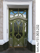 Antique green wooden door with carved decorations and glasses. Стоковое фото, фотограф Константин Григорьев / Фотобанк Лори