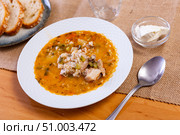 Popular dish of Russian cuisine is pickle soup with meat, cooked on basis of pickled cucumbers and pearl barley or rice, decorated with sprig of parsley. Стоковое фото, фотограф Яков Филимонов / Фотобанк Лори