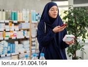 Young woman in hijab scans qr code of pills. Стоковое фото, фотограф Яков Филимонов / Фотобанк Лори
