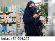 Young woman in hijab scans qr code of pills. Стоковое фото, фотограф Яков Филимонов / Фотобанк Лори