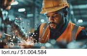 Skilled worker operates welding equipment in industrial setting during daytime hours. Стоковое AI-видео, аниматор Сергей Толмачёв / Фотобанк Лори