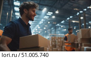 Dedicated worker sorts packages in busy warehouse during evening shift. Стоковое AI-видео, аниматор Сергей Толмачёв / Фотобанк Лори