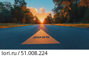 Witness a beautiful sunset illuminating a peaceful road adorned with a 2025 marker, showcasing nature's tranquility and promise of the future. Стоковое AI-видео, аниматор Данила Большаков / Фотобанк Лори