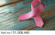 A pink ribbon placed on a weathered wooden surface highlights the ongoing campaign for breast cancer awareness during October. Стоковое AI-видео, аниматор Данила Большаков / Фотобанк Лори