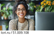 A joyful woman is focused on her work at home amidst vibrant plants and a computer, showcasing a warm and inviting atmosphere in autumn. Стоковое AI-видео, аниматор Данила Большаков / Фотобанк Лори