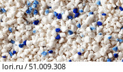 White cat litter round particles surface with small blue colored particles, top view. Granules of pet white-gray litter background. Dog litter texture backdrop with small dots. Flat lay, copy space. Стоковое AI-изображение, AI-художник Марина Демидюк / Фотобанк Лори