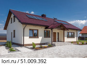 House Exterior. Roof Window. Second floor among blue sky. Mansard attic. Newly build houses. Gable roof with skylight, asphalt roofing, shingles. Residential Home. Vinyl Siding. Polymeric roof-tiles. Стоковое AI-изображение, AI-художник Марина Демидюк / Фотобанк Лори