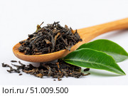 Dry black tea leaves in a wooden spoon isolated on white background. Pile of Dried fermented tea. Black Tea Leaves Heap. Close Up, Macro. Texture. Copy Space. Dried Tea. Abstract Food Drink Backdrop. Стоковое AI-изображение, AI-художник Марина Демидюк / Фотобанк Лори