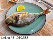 Dorada fish served on plate with lemon. Стоковое фото, фотограф Яков Филимонов / Фотобанк Лори