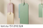 Minimalist video of pastel colored hanging price tags on neutral background. Стоковое AI-видео, аниматор Екатерина Усенко / Фотобанк Лори