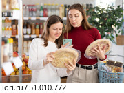Teenage girl and her mother scanning QR on pizza in supermarket. Стоковое фото, фотограф Яков Филимонов / Фотобанк Лори