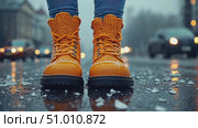 A person stands on a snowy street wearing bright orange winter boots, capturing the essence of a cold urban evening atmosphere. Стоковое AI-видео, аниматор Данила Большаков / Фотобанк Лори