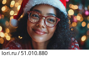 A joyful person shines in a festive atmosphere, adorned with a Santa hat and decorative glasses, surrounded by twinkling lights. Стоковое AI-видео, аниматор Данила Большаков / Фотобанк Лори