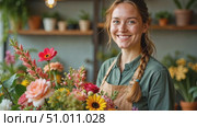 Shy young woman sells flower bouquets. Charming female entrepreneur with long braid smiles. Portrait of pretty student moonlighting as florist in flower shop. Стоковое AI-видео, аниматор Ирина / Фотобанк Лори