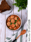 Soup with haddock fish balls in a gray bowl on white table. Top view. Стоковое фото, фотограф Оксана Чаюн / Фотобанк Лори