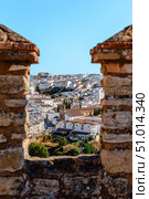 View of the town of Ronda, Spain, through a loophole in an ancient stone wall (2015 год). Стоковое фото, фотограф Татьяна  Бральнина / Фотобанк Лори