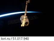 The SpaceX Dragon cargo craft with Earth's horizon in the background. Стоковое фото, фотограф Stocktrek Images, Inc. / ТАСС / Фотобанк Лори