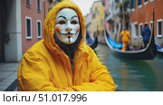A person wearing a yellow raincoat and mask stands near the calm waters of a Venetian canal, surrounded by colorful buildings on a serene day. Стоковое AI-видео, аниматор Данила Большаков / Фотобанк Лори