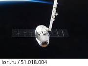 The SpaceX Dragon cargo craft prior to being released from the Canadarm2. Стоковое фото, фотограф Stocktrek Images, Inc. / ТАСС / Фотобанк Лори