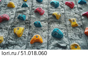 Climbers navigate a vibrant indoor rock wall filled with various colored holds, showcasing their skills during an afternoon practice. Стоковое AI-видео, аниматор Данила Большаков / Фотобанк Лори