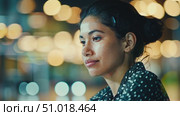 A woman quietly thinks and works at a cafe during the evening, surrounded by a warm ambiance created by soft glowing lights. Стоковое AI-видео, аниматор Данила Большаков / Фотобанк Лори
