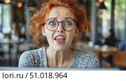 A woman expresses shock and disbelief as she interacts with her laptop in a bustling cafe filled with patrons enjoying their morning. Стоковое AI-видео, аниматор Данила Большаков / Фотобанк Лори
