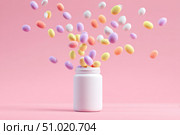Vitamin and health supplement white blank bottle with colorful pills flying out on a pink background. Flat lay, top view. Space for text. Bottle of various types multivitamins and tablets composition. Стоковое AI-изображение, AI-художник Марина Демидюк / Фотобанк Лори