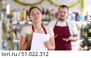 Angry salesman scolding at female assistant in hardware store decorated for New Year celebration. Стоковое видео, видеограф Яков Филимонов / Фотобанк Лори