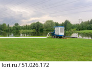 Park is flooded during the rains, the pump is pumping out the water. Стоковое фото, фотограф Евгений Харитонов / Фотобанк Лори