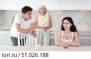 Upset woman dont speaking after discord with mother and husband standing behind. Стоковое видео, видеограф Яков Филимонов / Фотобанк Лори
