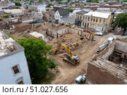 Excavator demolishing building in urban renewal project. Стоковое AI-изображение, AI-художник Юрий Поздников / Фотобанк Лори