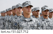 Soldiers standing in formation wearing camouflage uniforms. Стоковое AI-изображение, AI-художник Юрий Поздников / Фотобанк Лори