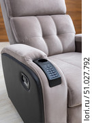 Modern recliner sofa featuring integrated control panel and cupholder. Стоковое AI-изображение, AI-художник Юрий Поздников / Фотобанк Лори