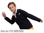 Portrait of a boy who imitates walking on a white background. The student runs and looks at the camera and smiles. Стоковое фото, фотограф Лазаренко Светлана / Фотобанк Лори