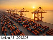 Expansive shipping port filled with colorful cargo containers and massive cranes under the golden light of sunrise over calm waters. Стоковое AI-изображение, AI-художник Башкирова Анна / Фотобанк Лори