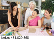 Adult woman teacher explains to group how to make pattern. Стоковое фото, фотограф Яков Филимонов / Фотобанк Лори