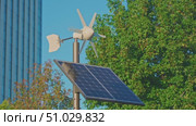 Tokyo, Japan - Oct 13 2024, 4k, panoramic view of the top of a street lamp with solar panels and a small wind turbine, without people, at daytime, in park in Tokyo, Japan. Стоковое видео, видеограф Сергей Богомяко / Фотобанк Лори