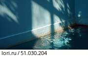 Tranquil blue water reflecting shadows in a serene indoor space during the day. Стоковое AI-изображение, AI-художник Сергей Толмачёв / Фотобанк Лори