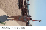 A 50-year-old European woman in a swimsuit is relaxing on a beach in Doha, Стоковое видео, видеограф IRYNA ZAKHARANKA / Фотобанк Лори