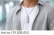 Wearable Air Purifier Necklace on Stylish Commuter in Modern Urban Lifestyle. Стоковое AI-изображение, AI-художник Katsiaryna Repich / Фотобанк Лори