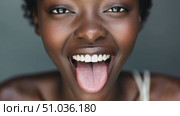 An energetic individual showcases a wide smile while playfully sticking out their tongue, exuding joy and positivity. Стоковое AI-видео, аниматор Данила Большаков / Фотобанк Лори