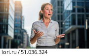 Business problem concept with shocked businesswoman suffering from heatwave in city, stressed female employee sweating in hot summer weather for climate change theme. Стоковое AI-изображение, AI-художник Павел Муравьев / Фотобанк Лори