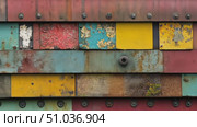 Discover a striking wall adorned with colorful patches and textures, revealing layers of paint, rust, and nature's reclaiming touch. Стоковое AI-видео, аниматор Данила Большаков / Фотобанк Лори