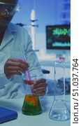 Scientist Conducts Experiment with Colorful Liquids in Laboratory Setting, Carefully Mixing Solutions to Observe Chemical Reactions and Properties in Glassware. Стоковое AI-видео, аниматор Владимир Федоров / Фотобанк Лори
