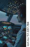 Focused Pilot Operating Advanced Flight Controls in a Modern Cockpit Environment at Dusk with Instrument Panel Illuminated and Monitoring Flight Data. Стоковое AI-видео, аниматор Владимир Федоров / Фотобанк Лори
