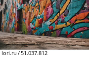 Wall adorned with an array of colorful graffiti art, showcasing a diverse range of artistic styles and imagery. Стоковое AI-видео, аниматор Данила Большаков / Фотобанк Лори