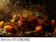 Juicy grilled steak with spices and herbs falling on it. Стоковое AI-изображение, AI-художник Иван Рябоконь / Фотобанк Лори