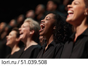 Gospel choir singing with joy and enthusiasm during performance. Стоковое AI-изображение, AI-художник Иван Рябоконь / Фотобанк Лори