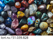 Colorful tumbled gemstones creating a vibrant and captivating background. Стоковое AI-изображение, AI-художник Иван Рябоконь / Фотобанк Лори