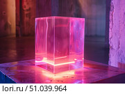 Empty illuminated plexiglas cube displaying vibrant magenta light in modern art gallery. Стоковое AI-изображение, AI-художник Иван Рябоконь / Фотобанк Лори